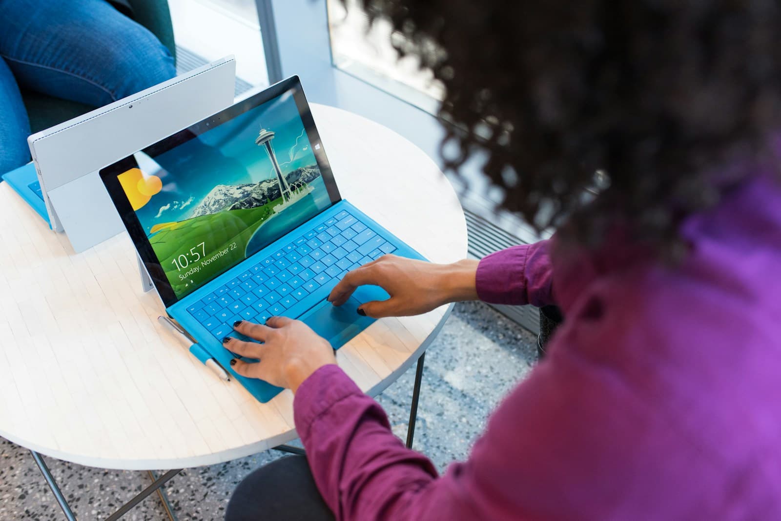 Analyst writing a security assessment report on a laptop with reference documents