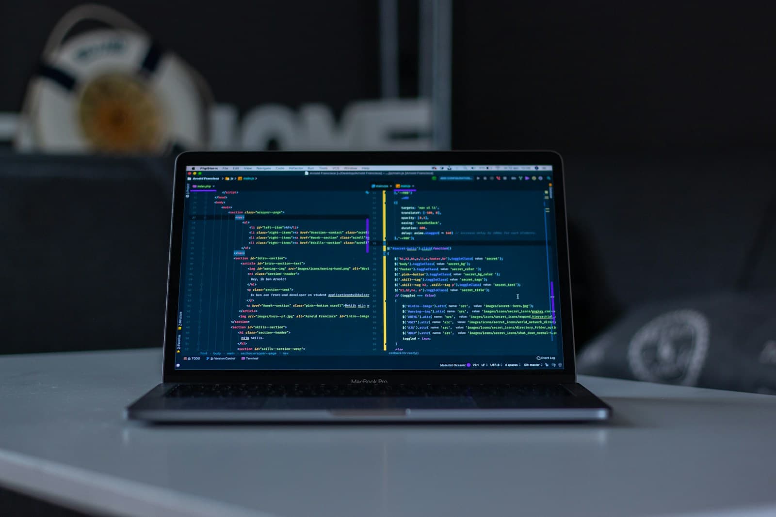 Developer reviewing web application source code on a widescreen monitor