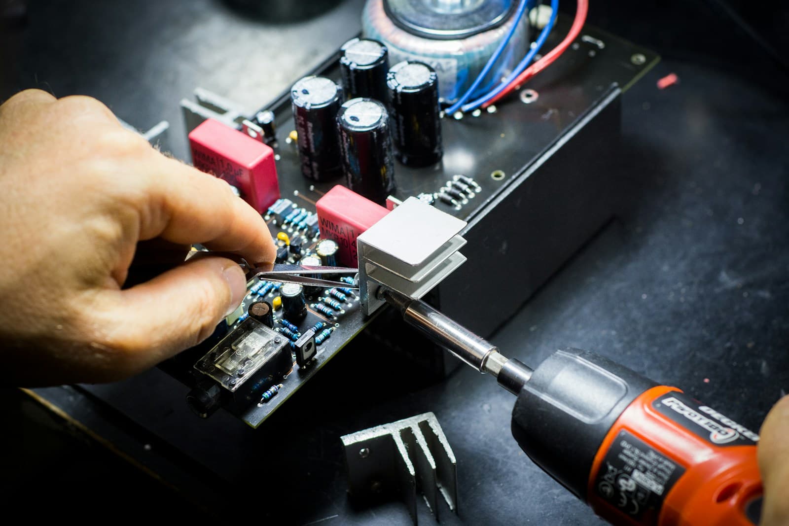 Engineer working at a server rack (photo by Field Engineer on Unsplash)