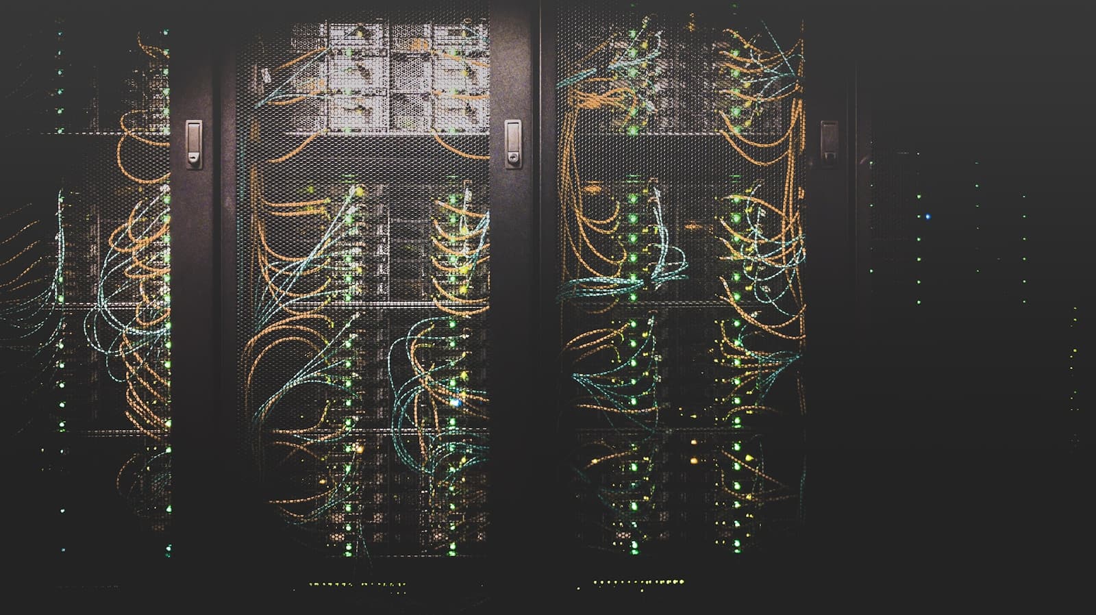 Data centre with glowing server racks and cable management (photo on Unsplash)