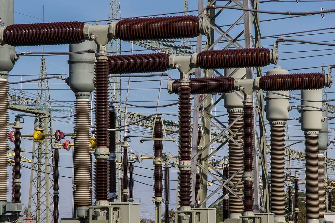 High-voltage switchgear and insulators at an electrical substation